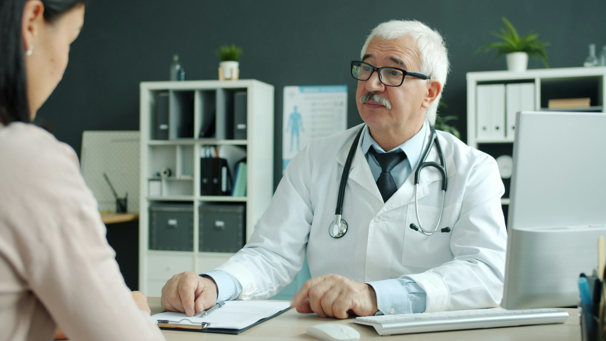 Clinician consulting with a patient